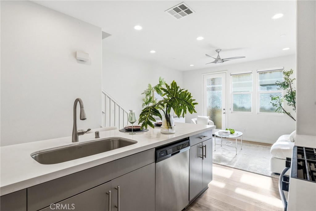 11130 Legion Loop, Unit 105 El Monte, CA 91731 - Photo 7 of 49 a kitchen with a sink and living room