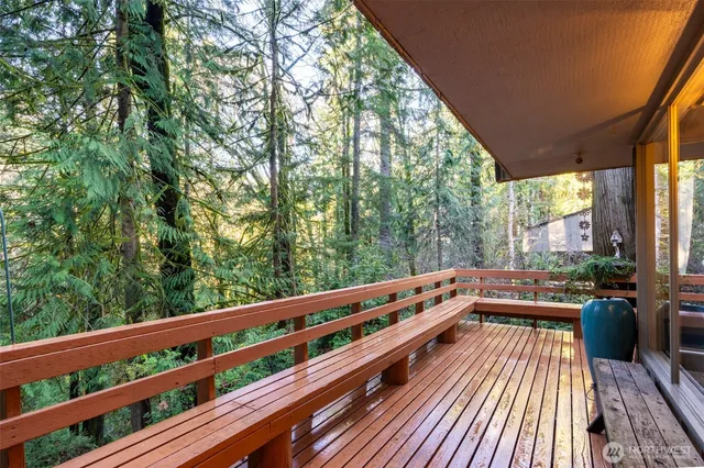 a view of balcony with mountain view and wooden floor