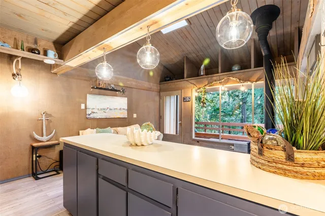 a kitchen with a sink appliances and a large window