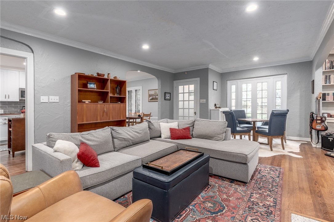 Hardwood floored living room with ornamental molding