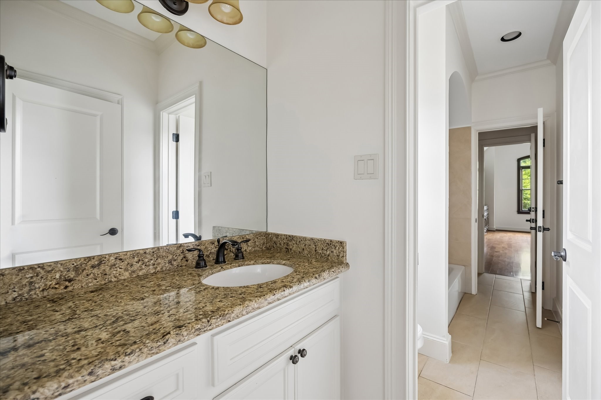 2246 Branard Street Houston, TX 77098 - Photo 32 of 40 Jack-and-Jill bath featuring granite countertops, generous storage, and convenient access between the secondary bedrooms.