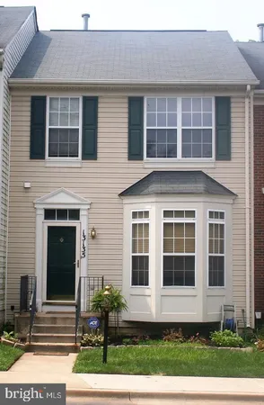a front view of a house with a yard and outdoor seating