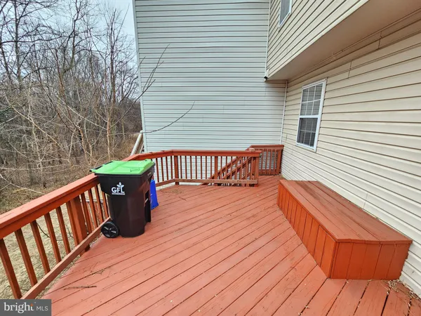 a balcony with wooden floor and furniture