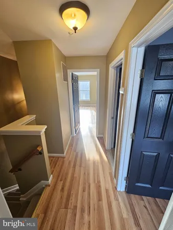 a view of a room with wooden floor and staircase