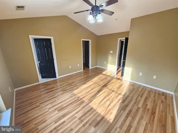 a view of a room with wooden floor