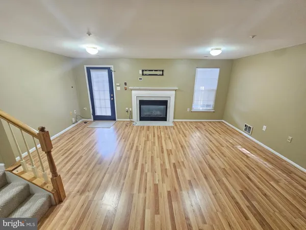 a view of a room with wooden floor and stairs