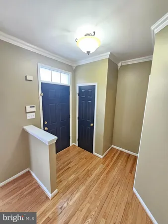 a view of a room with wooden floor and cabinet