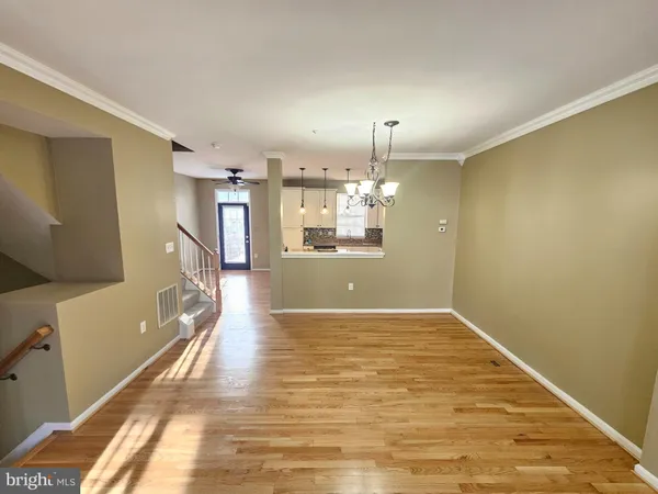 a view of a kitchen with a sink and wooden floor