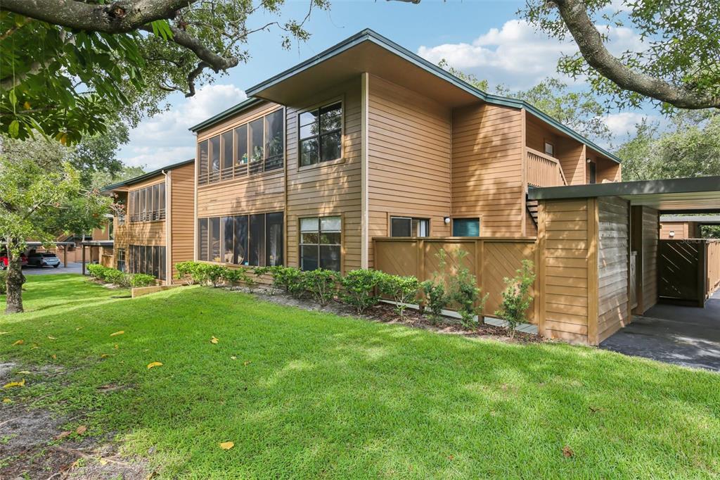 a front view of house with yard and green space
