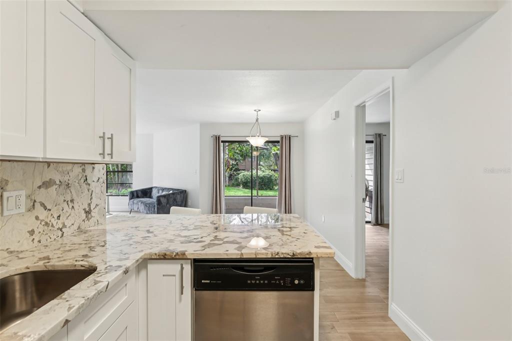 2407 Cypress Pond Road, Unit 2407 Palm Harbor, FL 34683 - Photo 12 of 28 a kitchen with granite countertop a sink and a stove