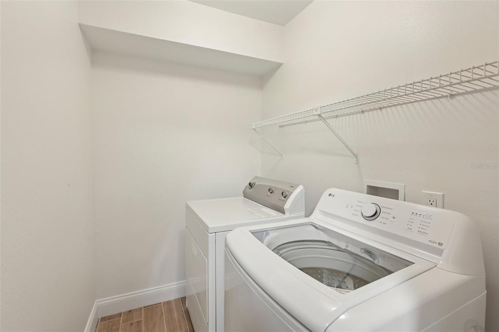 2407 Cypress Pond Road, Unit 2407 Palm Harbor, FL 34683 - Photo 13 of 28 a utility room with dryer and washer