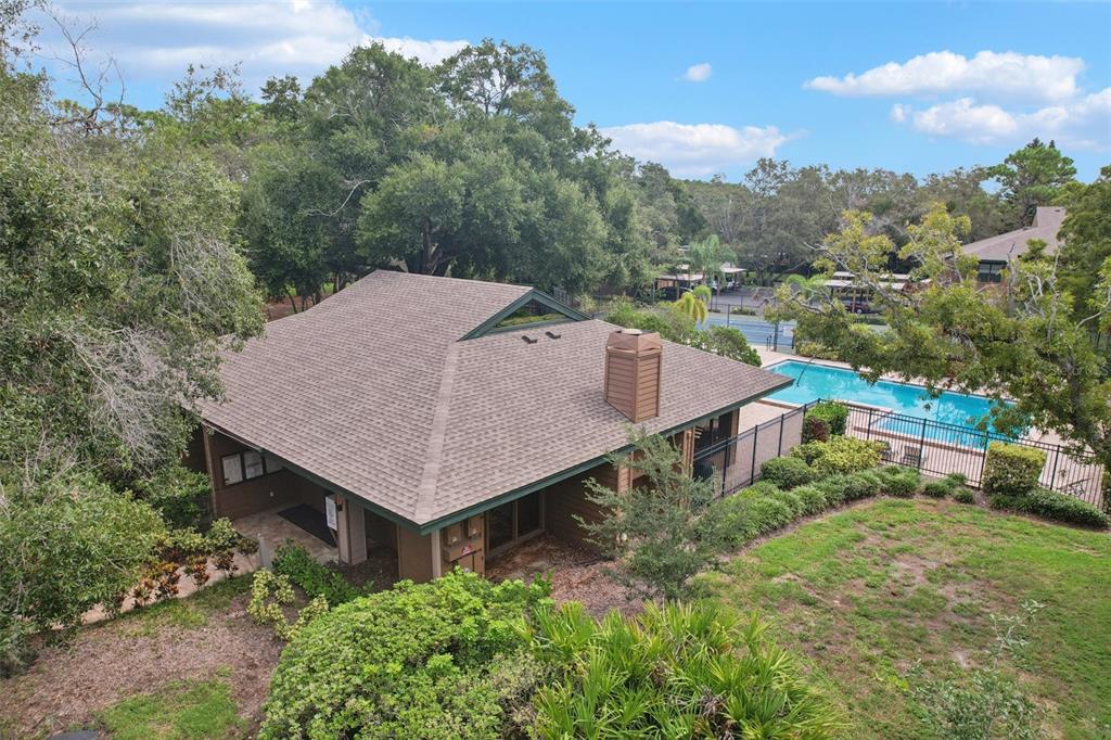 2407 Cypress Pond Road, Unit 2407 Palm Harbor, FL 34683 - Photo 25 of 28 an aerial view of a house with yard and trees in the background