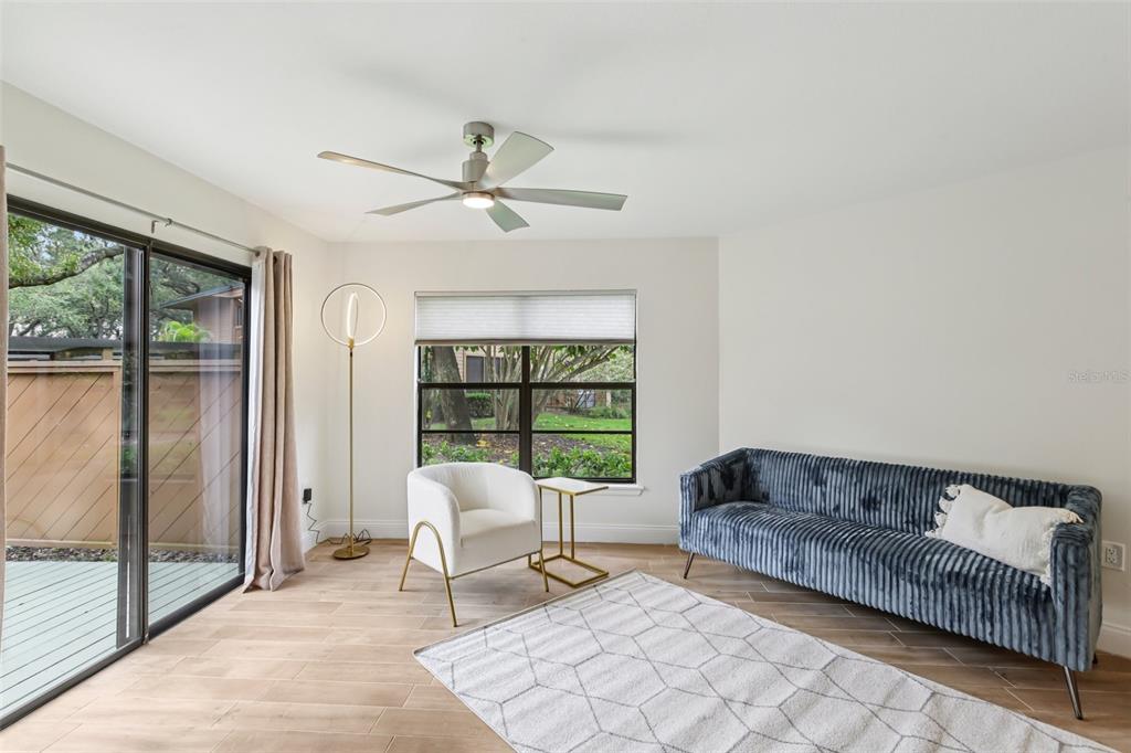 2407 Cypress Pond Road, Unit 2407 Palm Harbor, FL 34683 - Photo 5 of 28 a living room with furniture and a floor to ceiling window