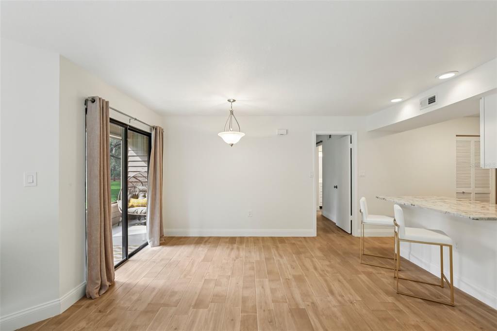 2407 Cypress Pond Road, Unit 2407 Palm Harbor, FL 34683 - Photo 7 of 28 wooden floor in an empty room with a window