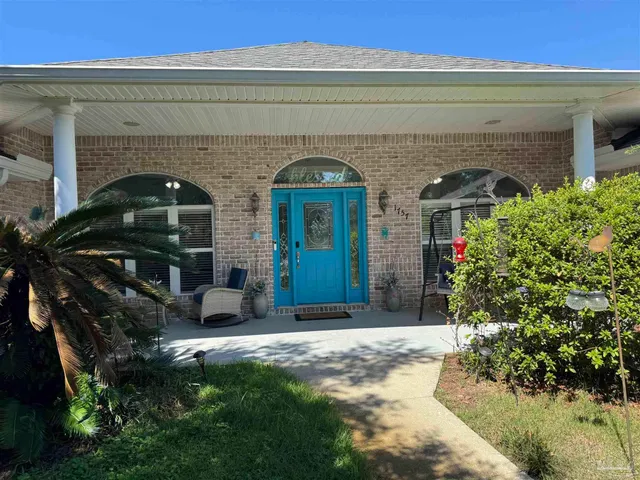 a front view of a house with garden