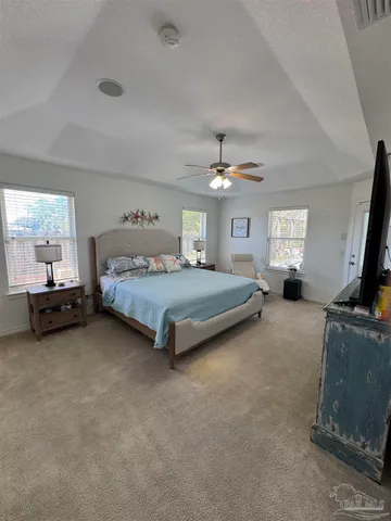 a spacious bedroom with a bed and furniture