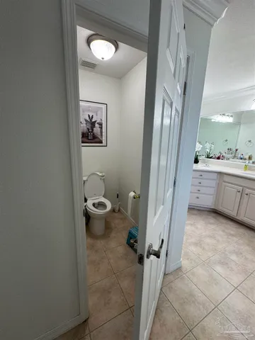 a bathroom with a granite countertop sink mirror and toilet