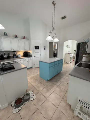 a kitchen with stainless steel appliances kitchen island granite countertop a sink and cabinets