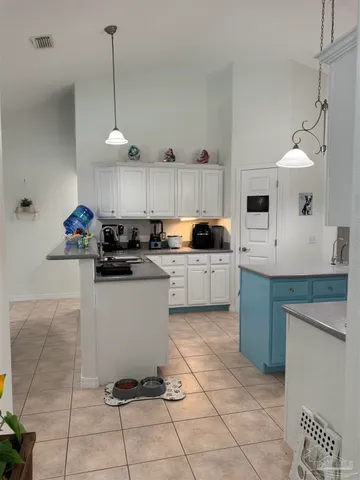 a kitchen with a sink a counter and cabinets