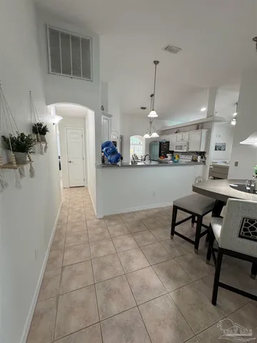 a kitchen with stainless steel appliances kitchen island granite countertop a rug a stove a microwave and a counter top space