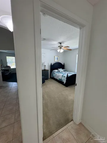 a bedroom with a bed and chandelier