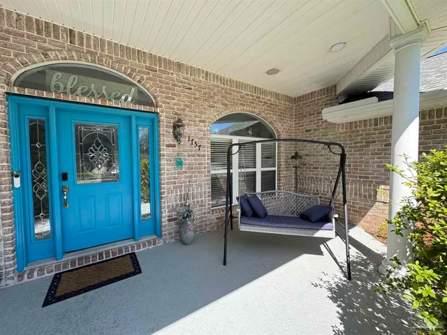 a front view of a house with outdoor seating