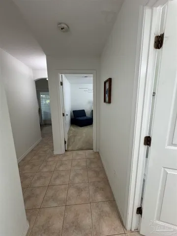 a view of a hallway to rooms