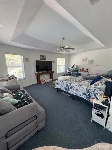 a bedroom with furniture and a window