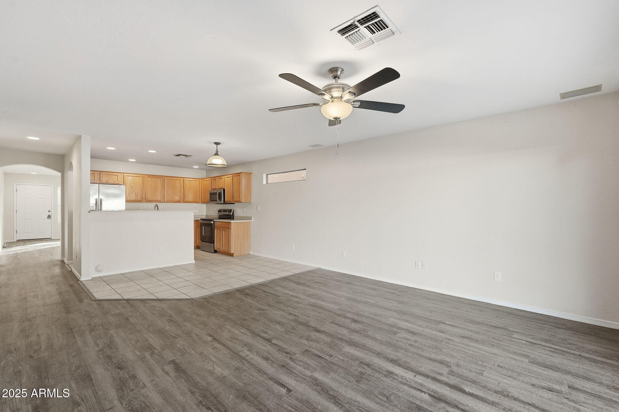 6782 West Rowel Road Peoria, AZ 85383 - Photo 9 of 42 a view of a kitchen with wooden floor and a sink