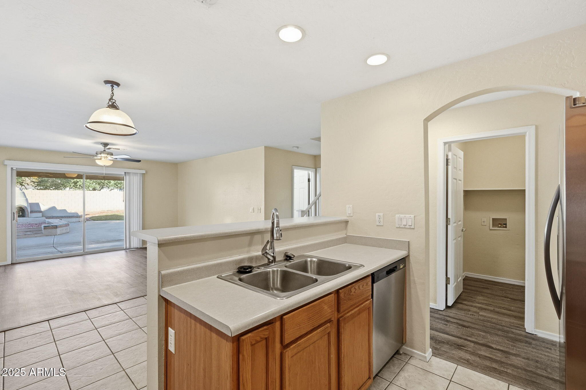 6782 West Rowel Road Peoria, AZ 85383 - Photo 12 of 42 a kitchen that has a sink a window and stainless steel appliances