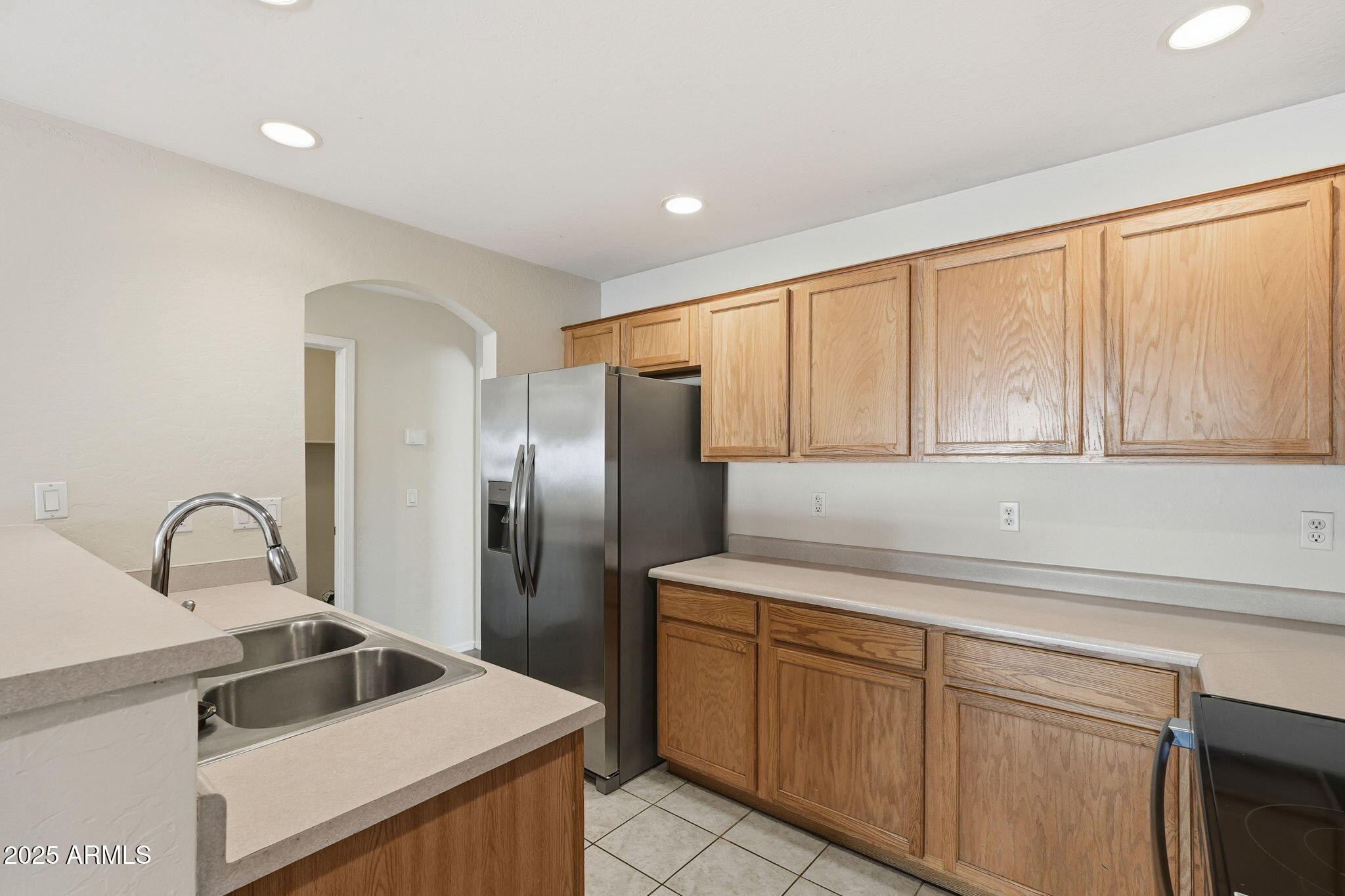6782 West Rowel Road Peoria, AZ 85383 - Photo 13 of 42 a kitchen with stainless steel appliances granite countertop a sink and a refrigerator