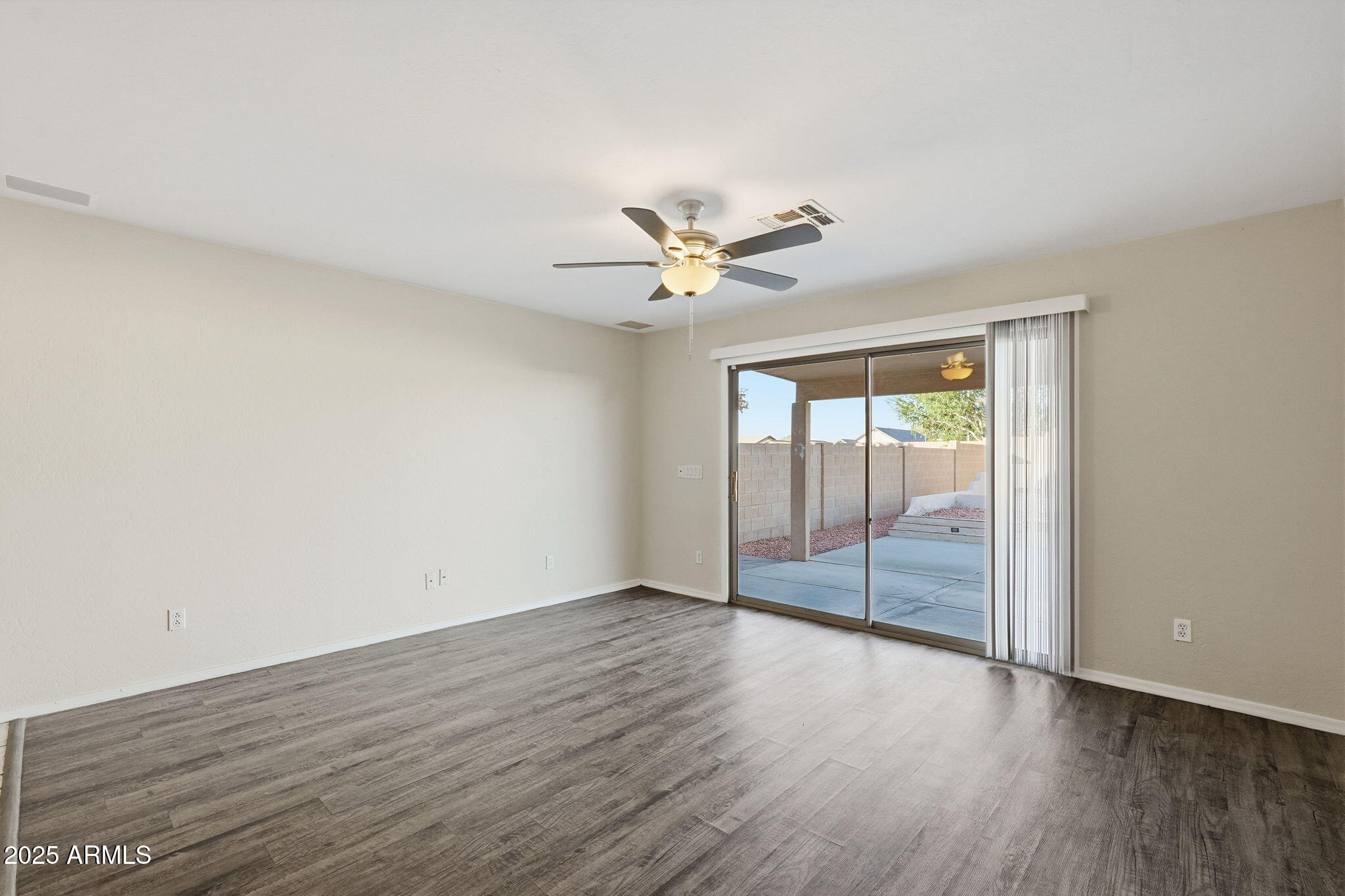 6782 West Rowel Road Peoria, AZ 85383 - Photo 16 of 42 an empty room with wooden floor and fan