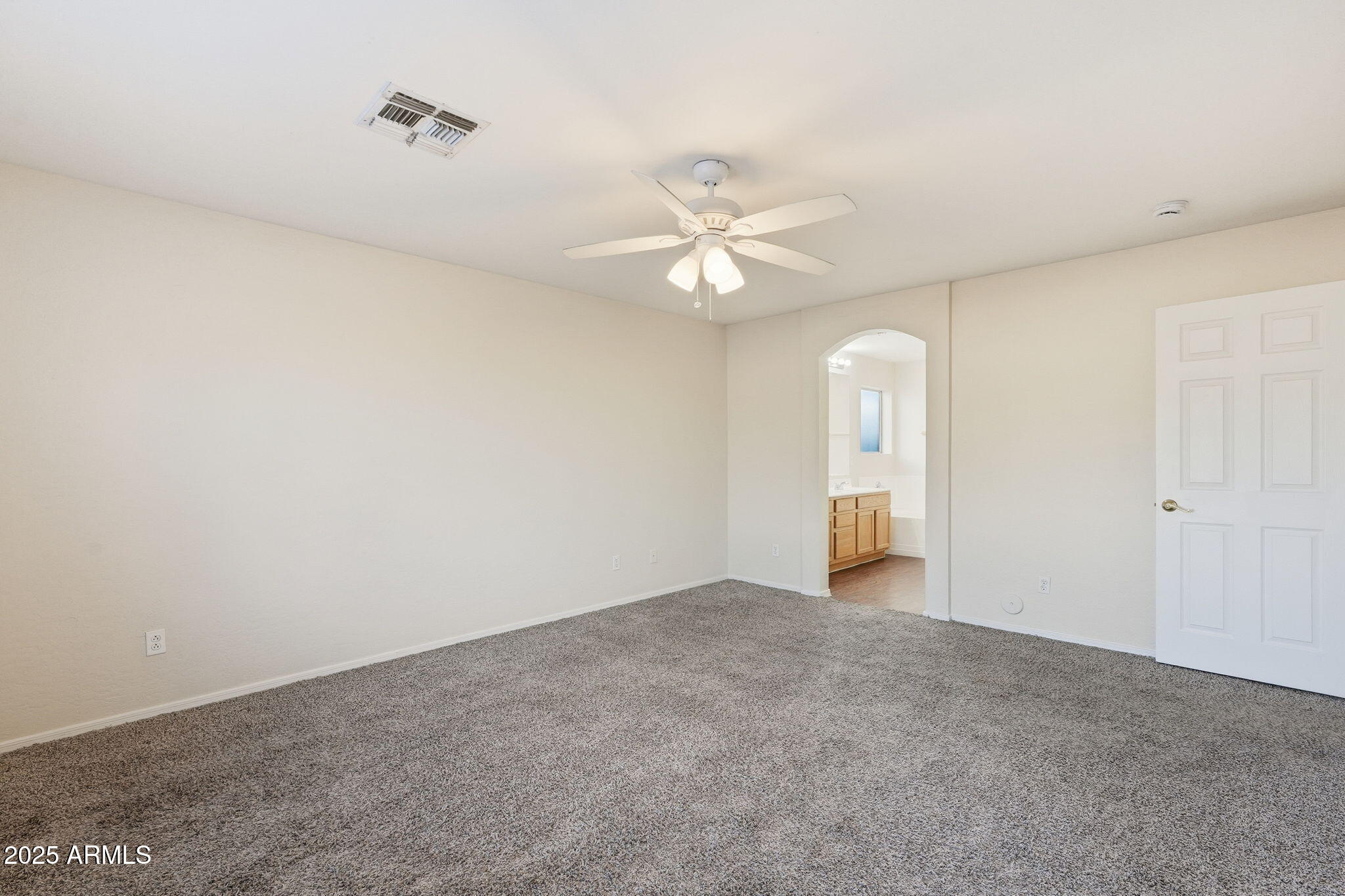 6782 West Rowel Road Peoria, AZ 85383 - Photo 21 of 42 a view of an empty room with a ceiling fan