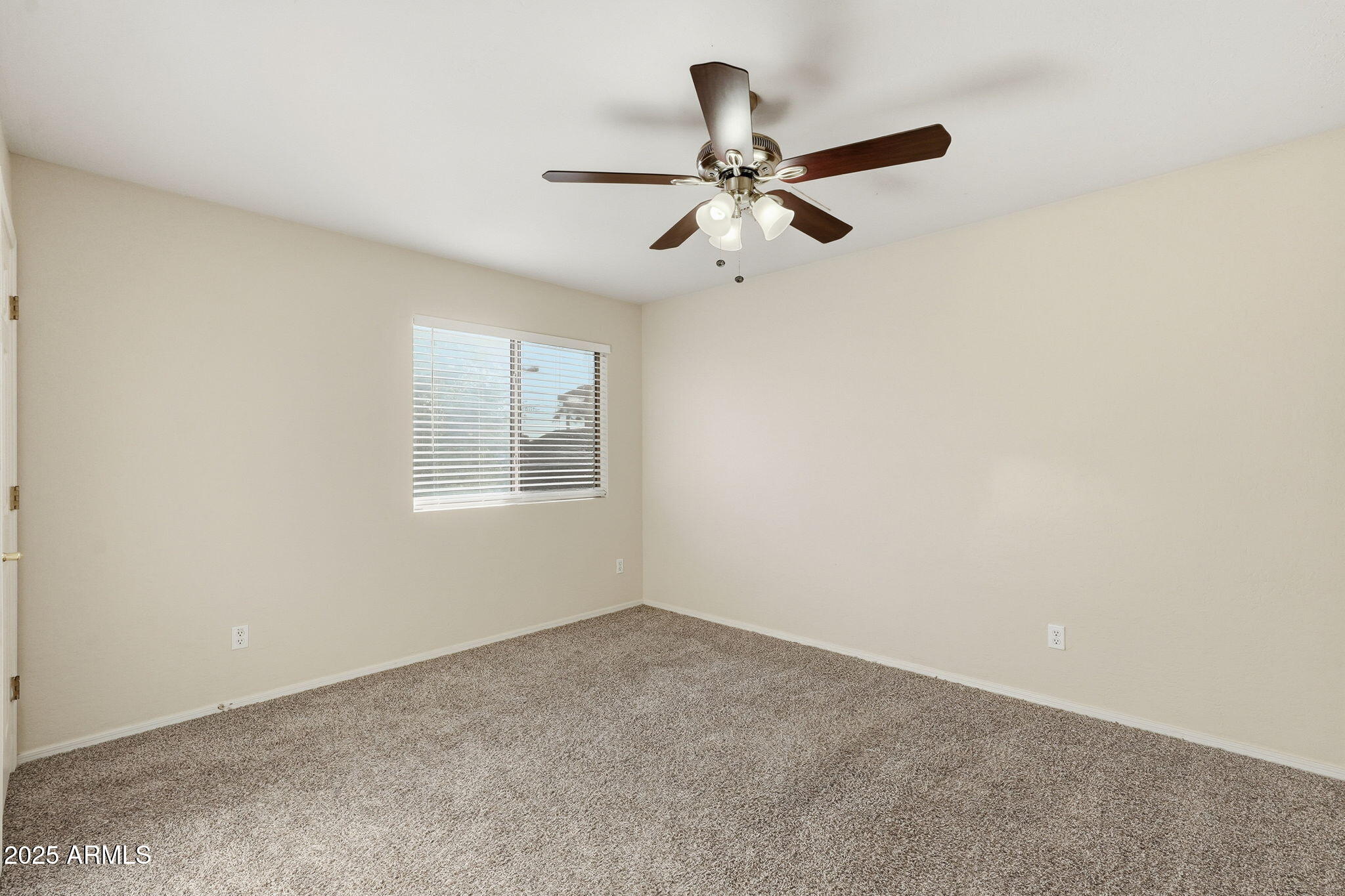 6782 West Rowel Road Peoria, AZ 85383 - Photo 22 of 42 a view of a room with a ceiling fan and window