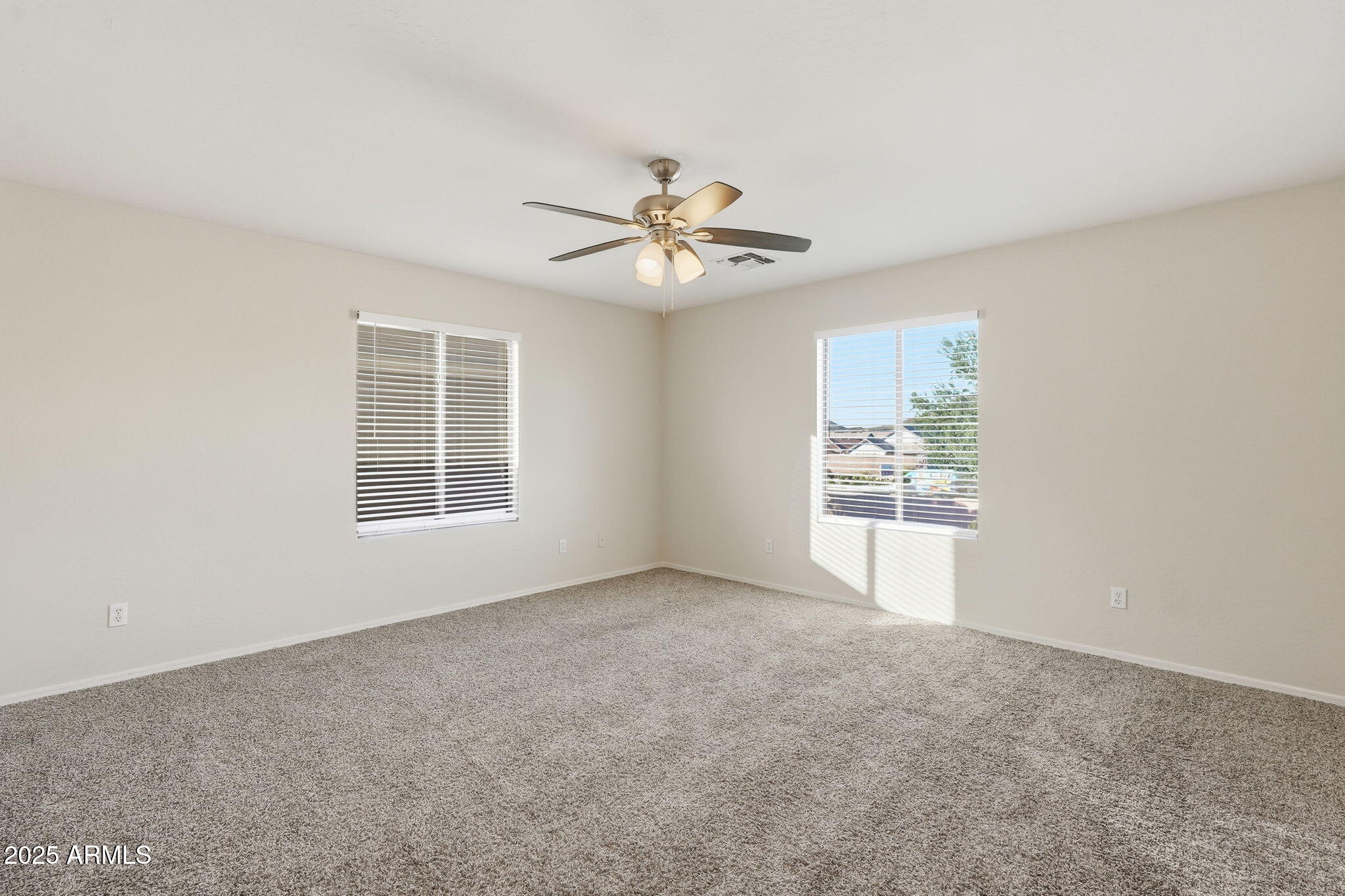 6782 West Rowel Road Peoria, AZ 85383 - Photo 24 of 42 an empty room with chandelier fan and windows