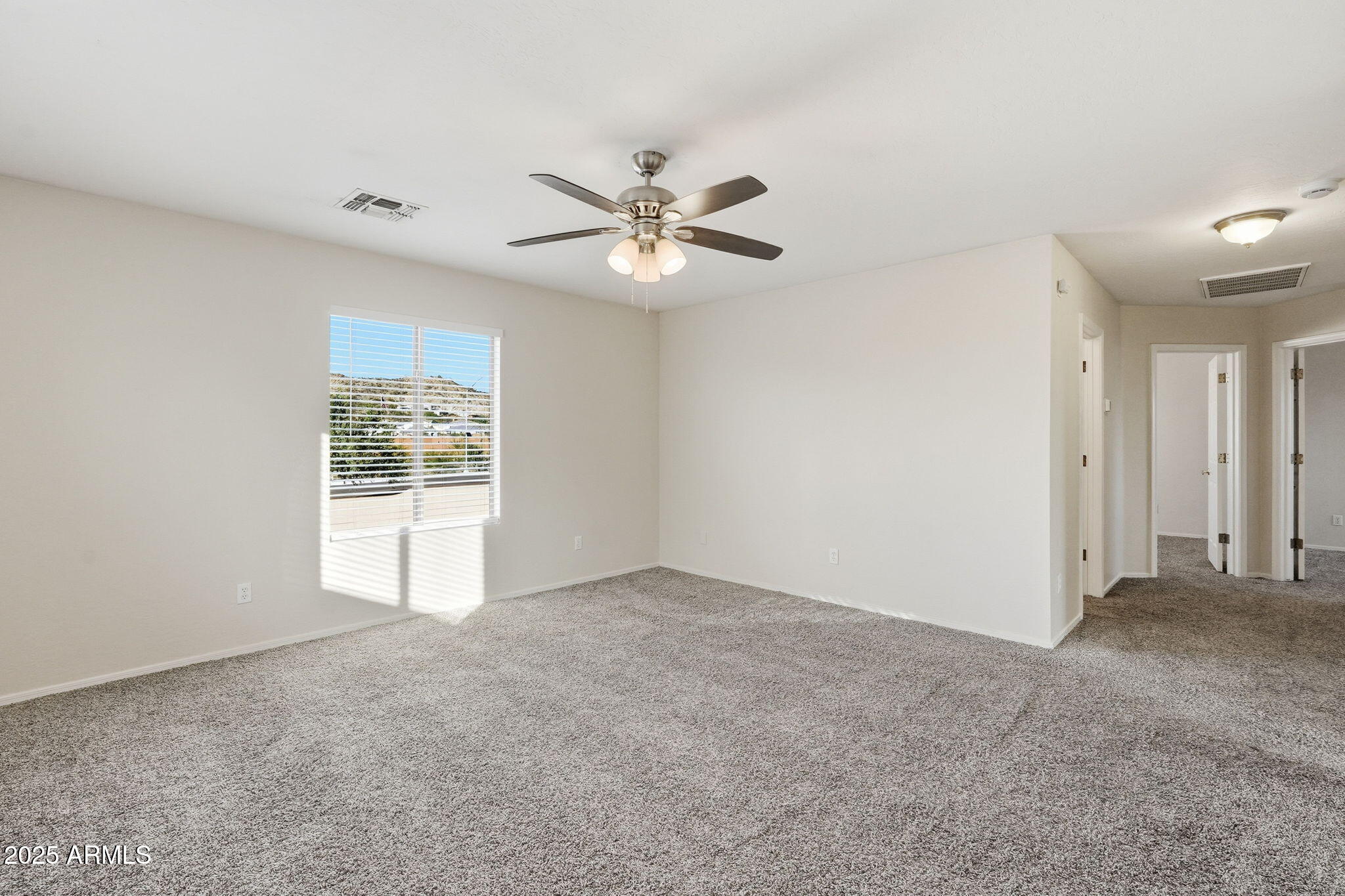 6782 West Rowel Road Peoria, AZ 85383 - Photo 25 of 42 an empty room with windows and fan