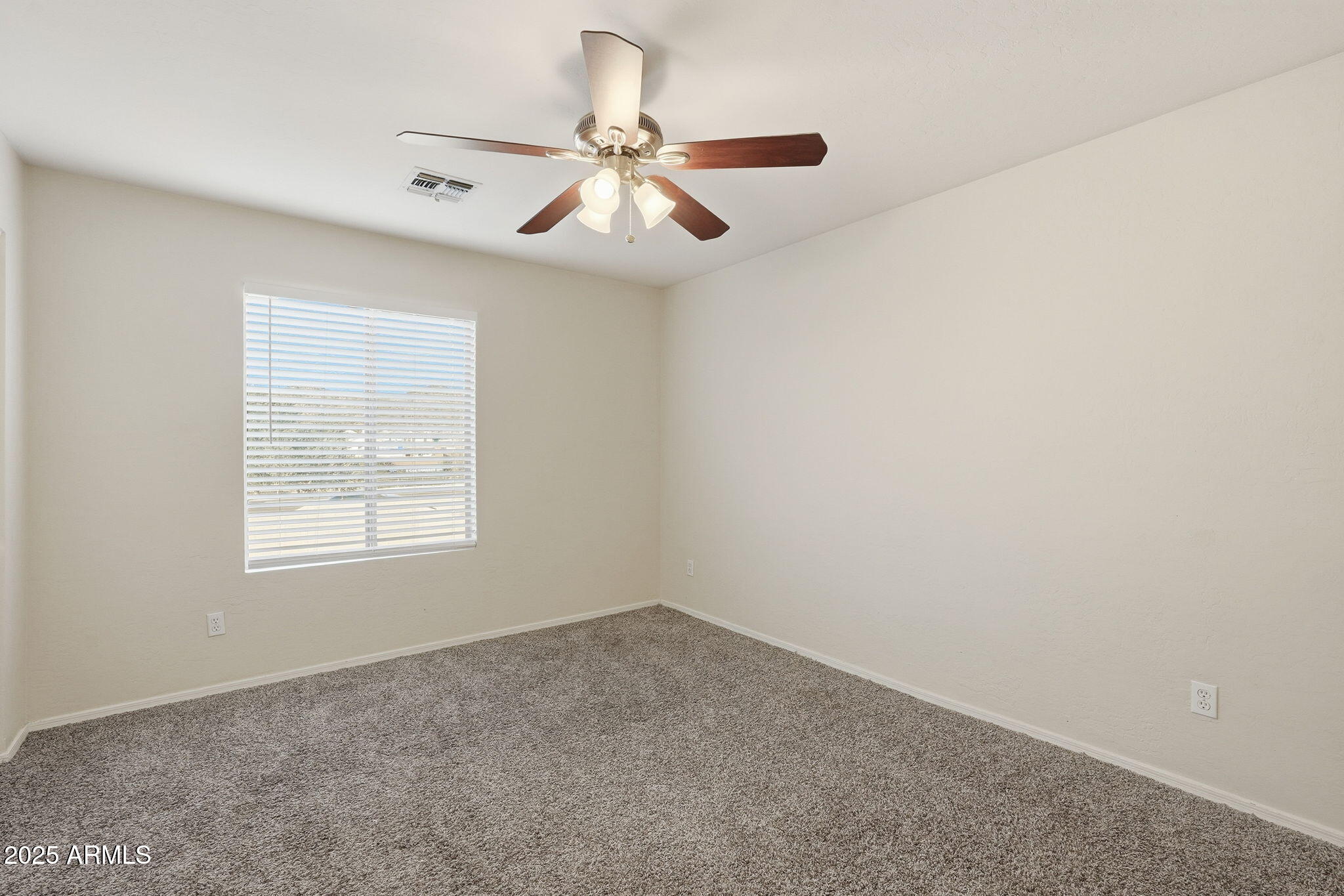 6782 West Rowel Road Peoria, AZ 85383 - Photo 27 of 42 an empty room with a window and a fan