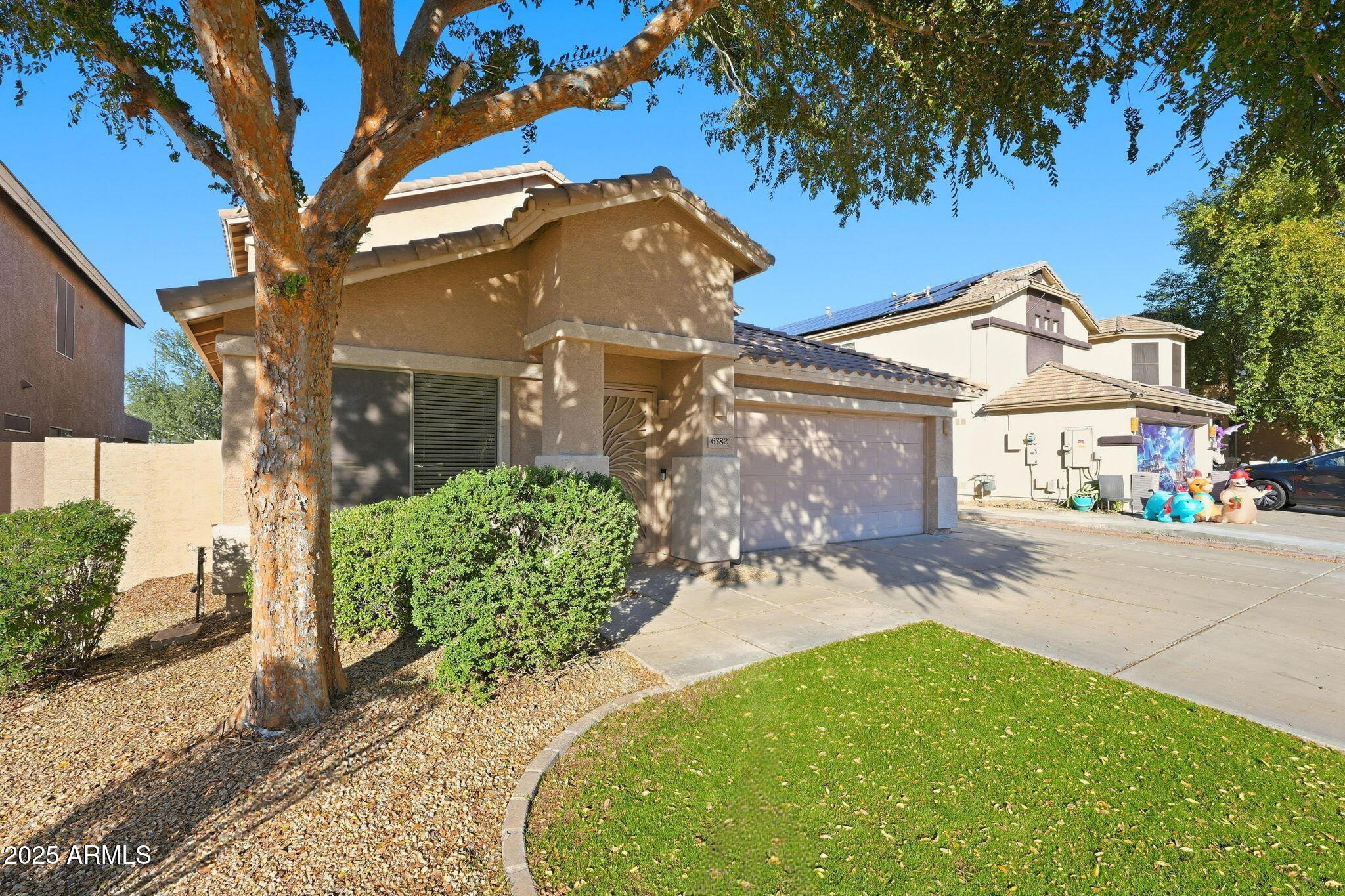 6782 West Rowel Road Peoria, AZ 85383 - Photo 2 of 42 a front view of a house with garden