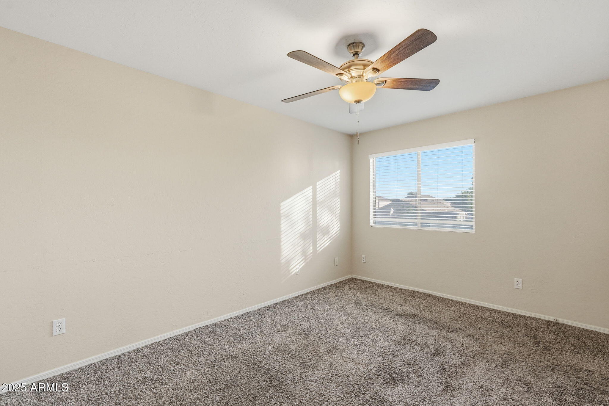 6782 West Rowel Road Peoria, AZ 85383 - Photo 29 of 42 an empty room with windows and fan