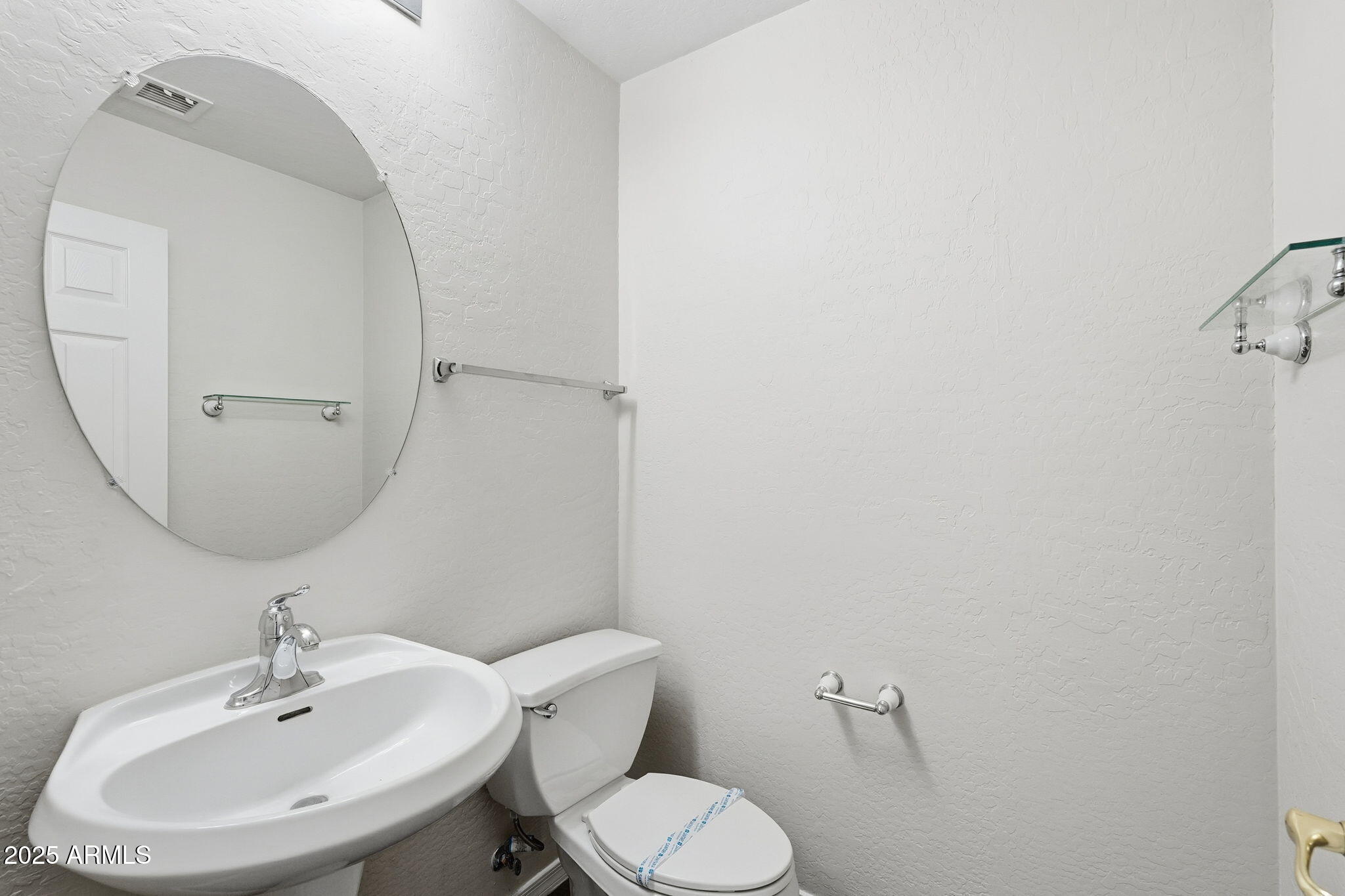 6782 West Rowel Road Peoria, AZ 85383 - Photo 32 of 42 a bathroom with a sink mirror and toilet