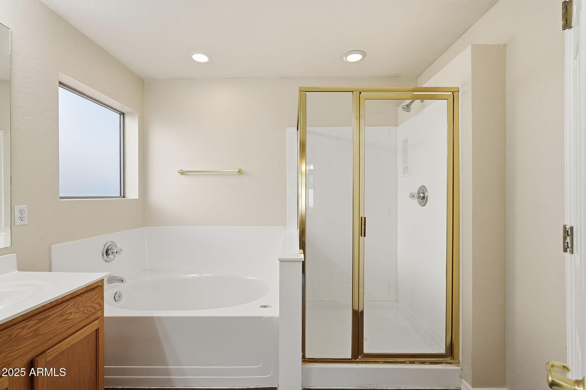 6782 West Rowel Road Peoria, AZ 85383 - Photo 34 of 42 a bathroom with a bathtub and a shower