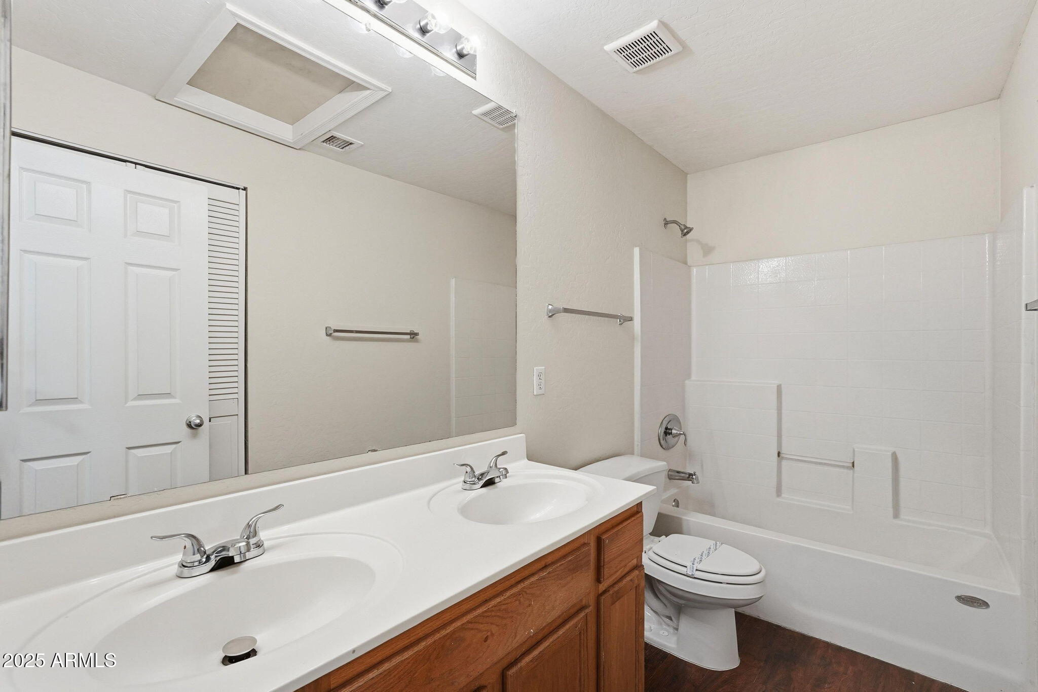 6782 West Rowel Road Peoria, AZ 85383 - Photo 35 of 42 a bathroom with a sink toilet a mirror and shower