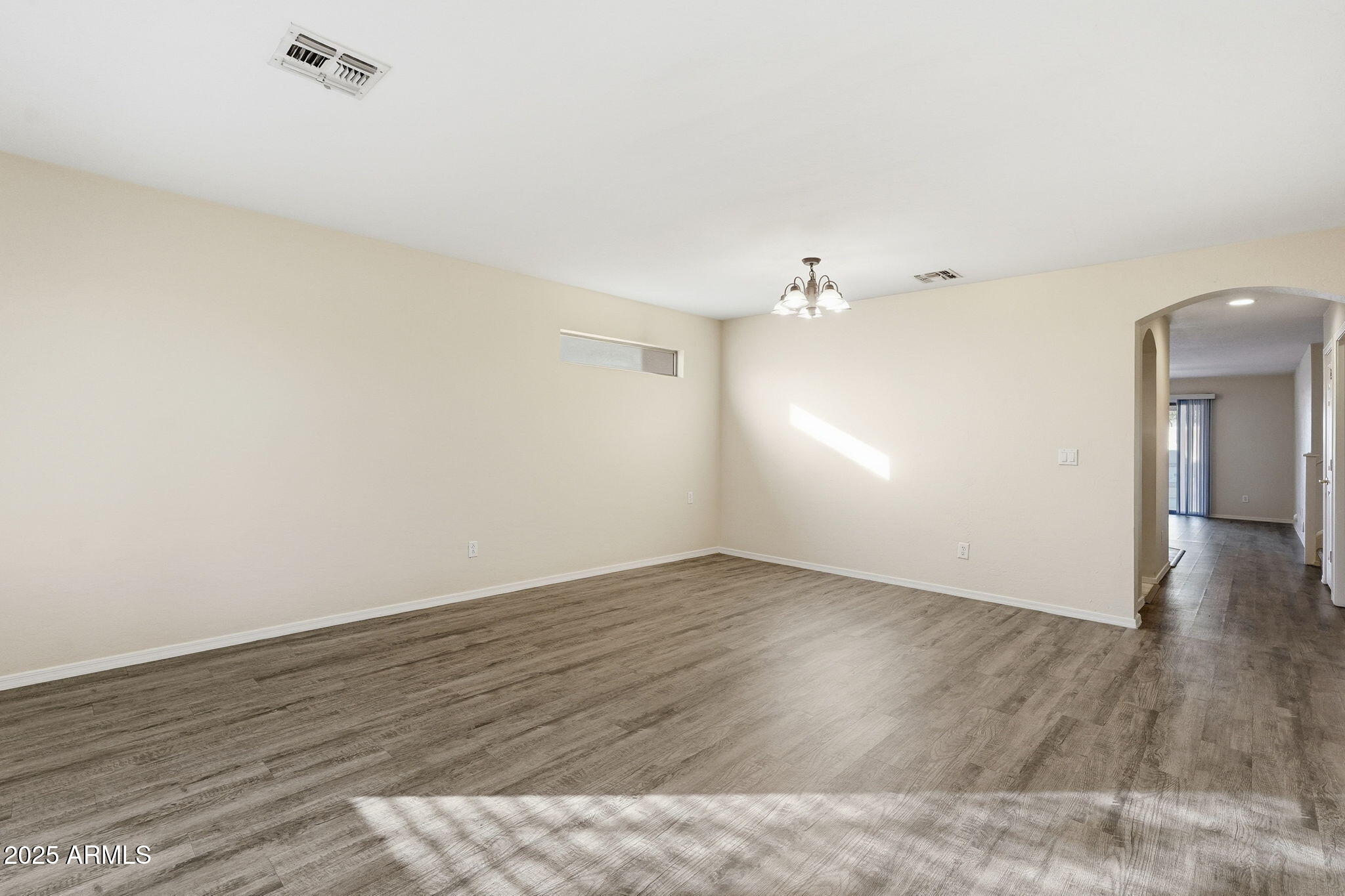 6782 West Rowel Road Peoria, AZ 85383 - Photo 4 of 42 a view of an empty room with wooden floor
