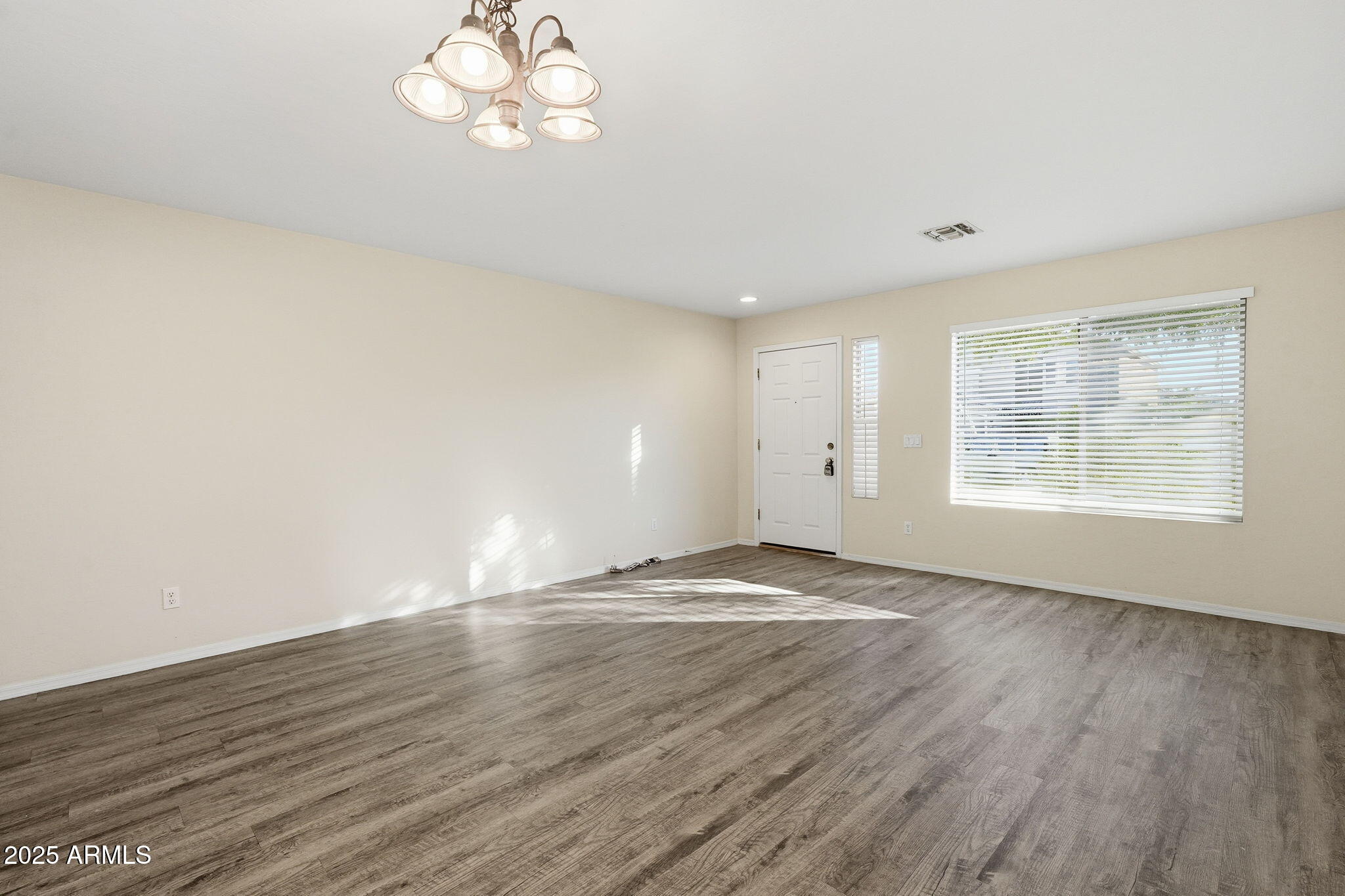 6782 West Rowel Road Peoria, AZ 85383 - Photo 5 of 42 an empty room with wooden floor and windows