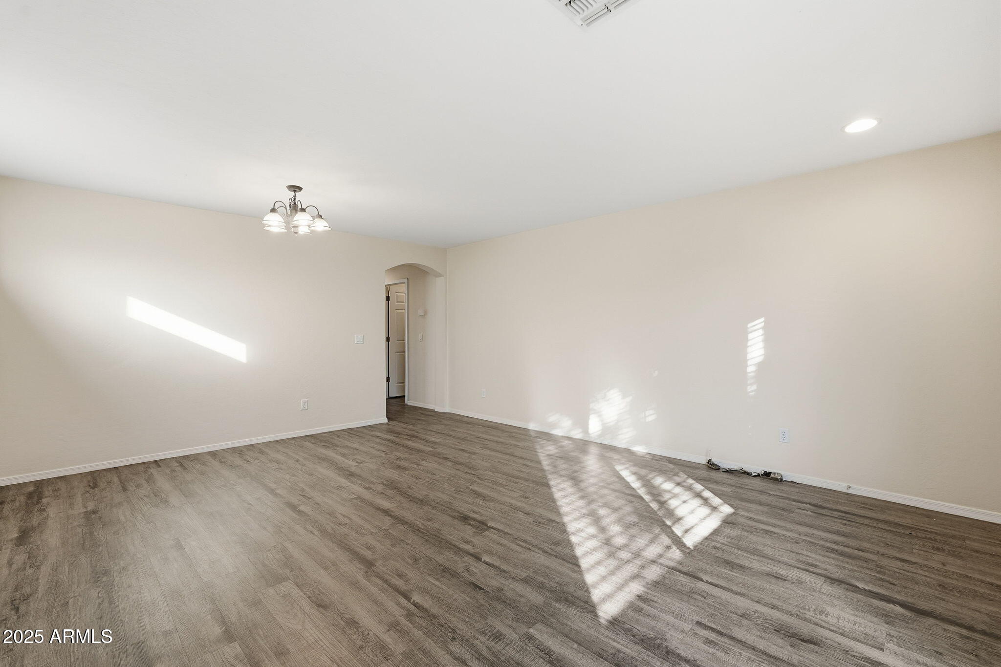 6782 West Rowel Road Peoria, AZ 85383 - Photo 7 of 42 a view of an empty room with wooden floor