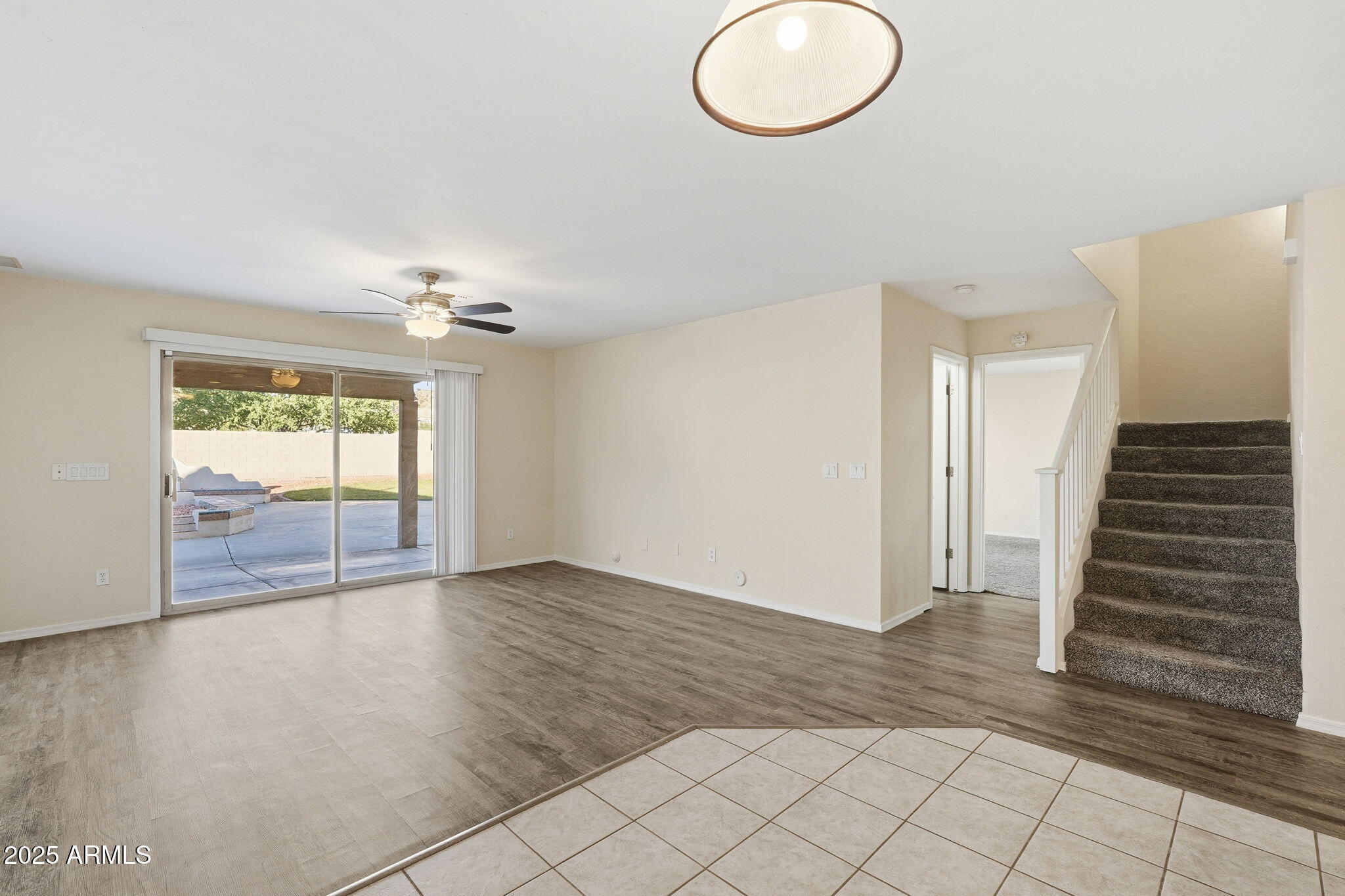 6782 West Rowel Road Peoria, AZ 85383 - Photo 8 of 42 an empty room with wooden floor and windows