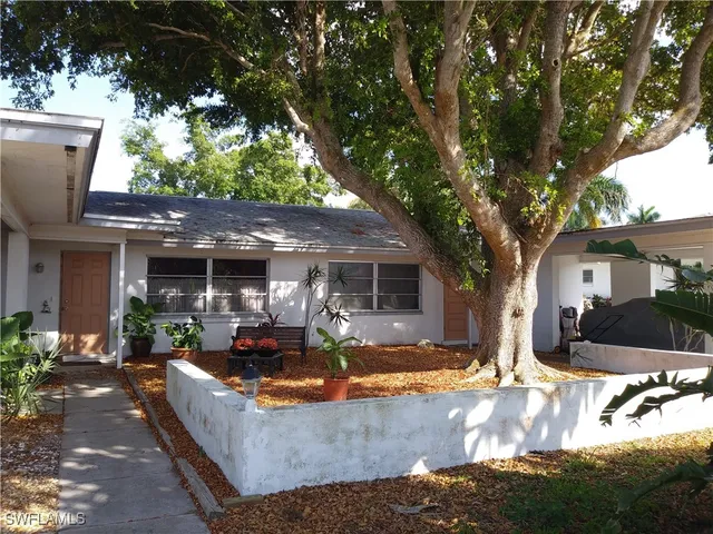 a view of a house with a yard patio and a fire pit