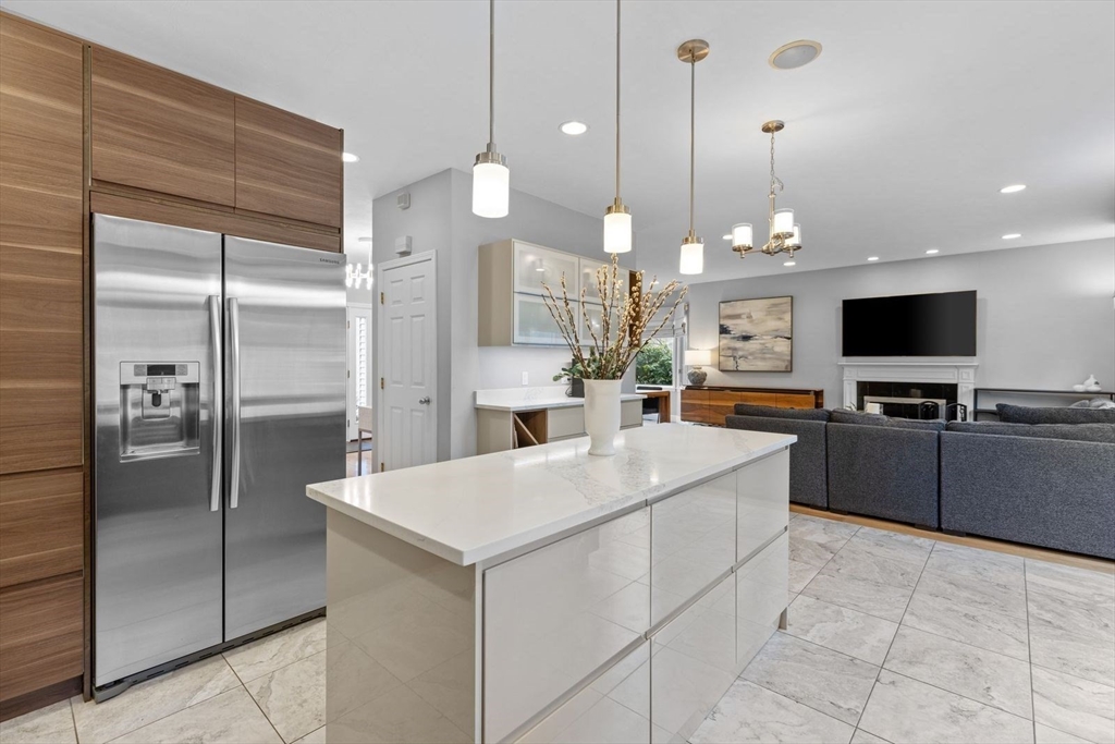 5 Sullivan Way Canton, MA 02021 - Photo 14 of 40 a large kitchen with kitchen island a refrigerator a stove a sink and a large mirror