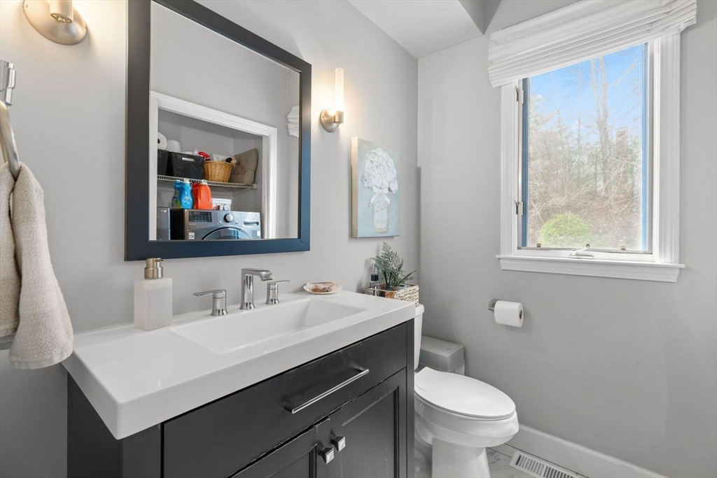 5 Sullivan Way Canton, MA 02021 - Photo 17 of 40 a bathroom with a toilet a sink a vanity and mirror