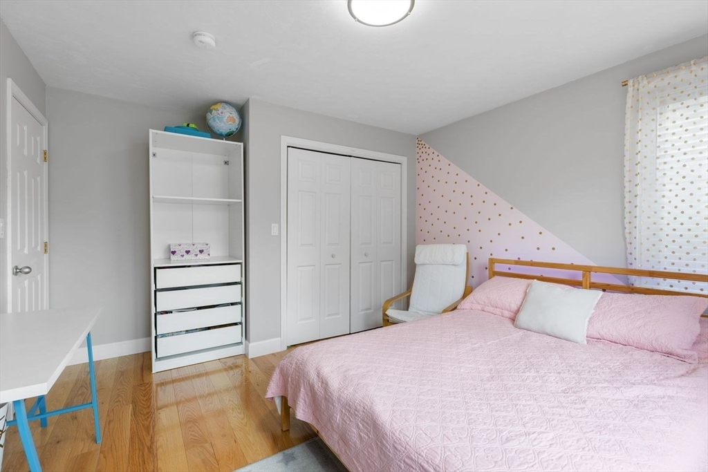 5 Sullivan Way Canton, MA 02021 - Photo 21 of 40 a bedroom with a bed and cabinets